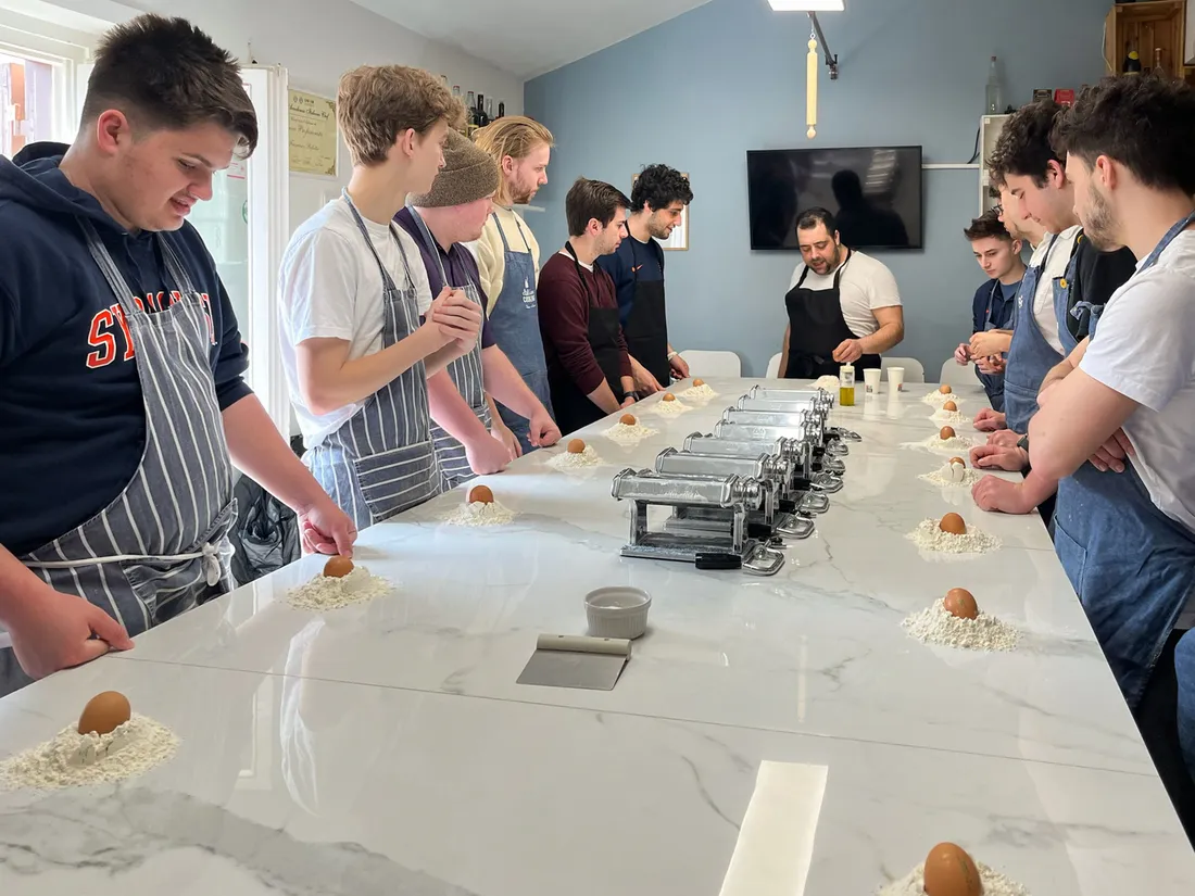 People in a pasta making class.