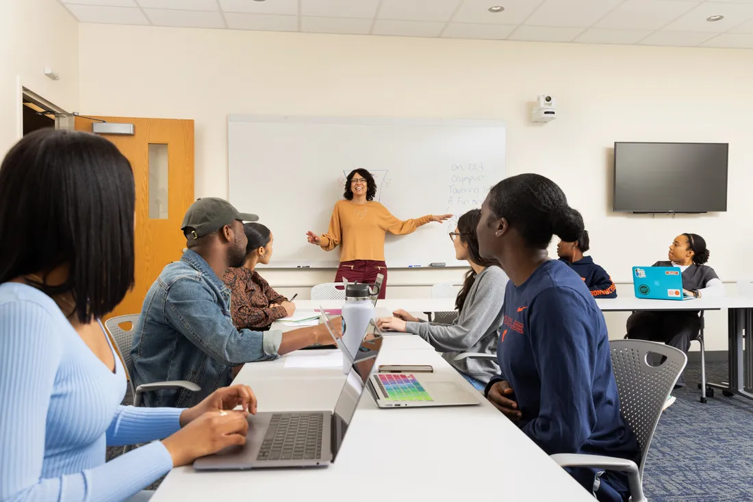 Soren Lowell talking to students sitting in front of her in a classroom.