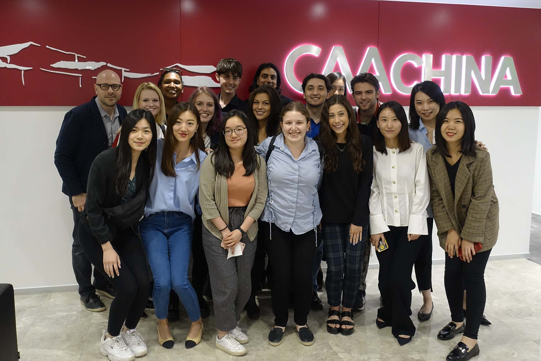 Class poses for a photo at CAA China.