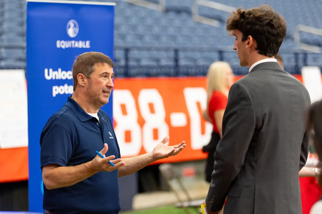People talking at a career fair.
