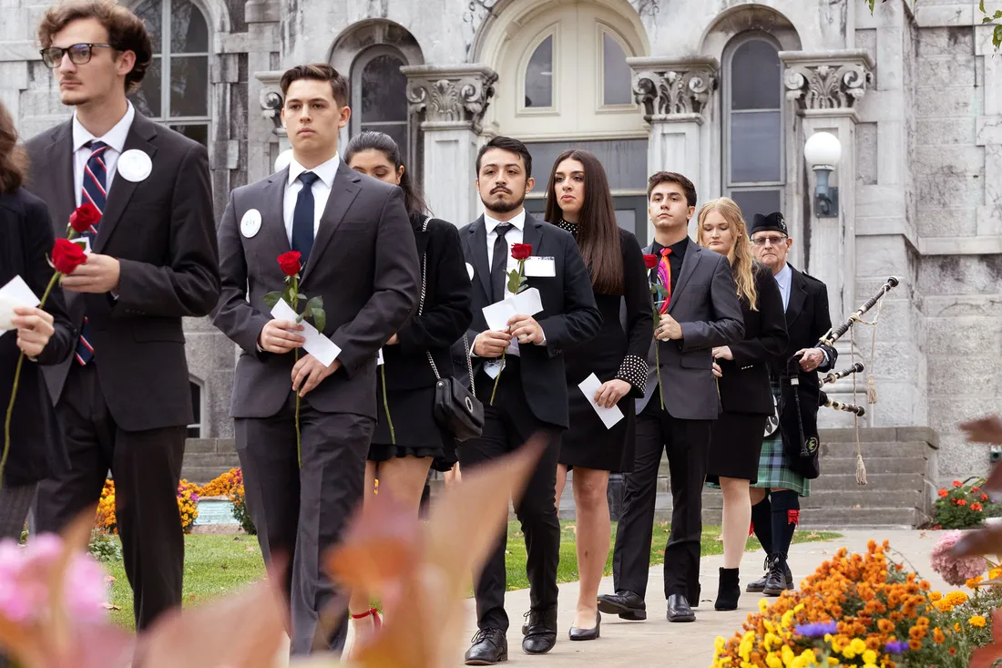 People walking with roses.