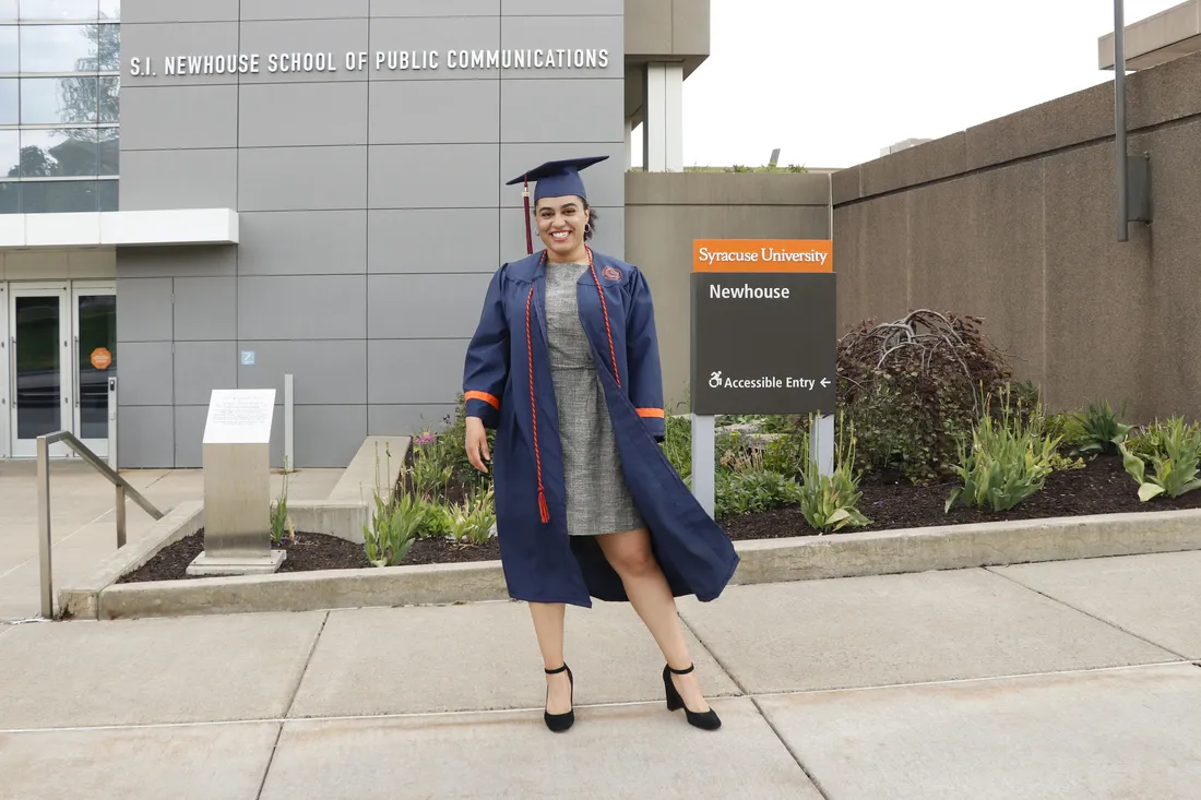 Carmella Boykin standing outside of the S.I. Newhouse School of Public Communications on her graduation day.