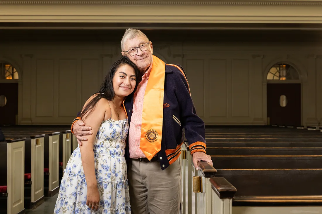 Two people hugging and smiling in Hendricks Chapel.