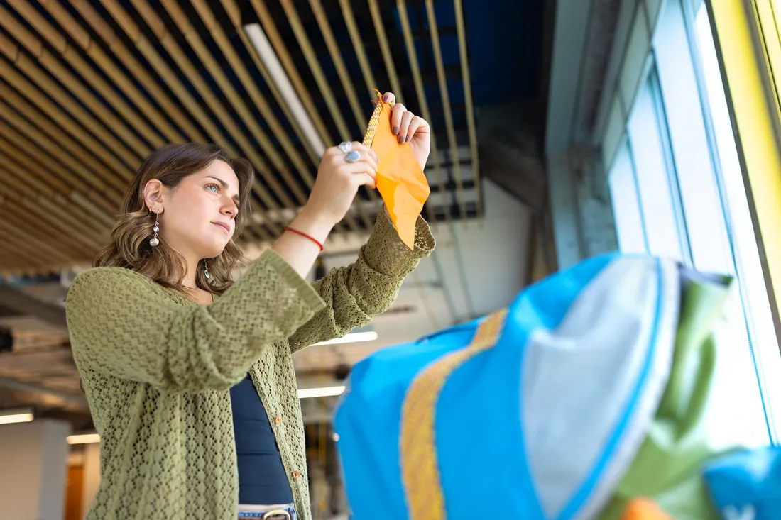 Student holding up a swatch for her product.