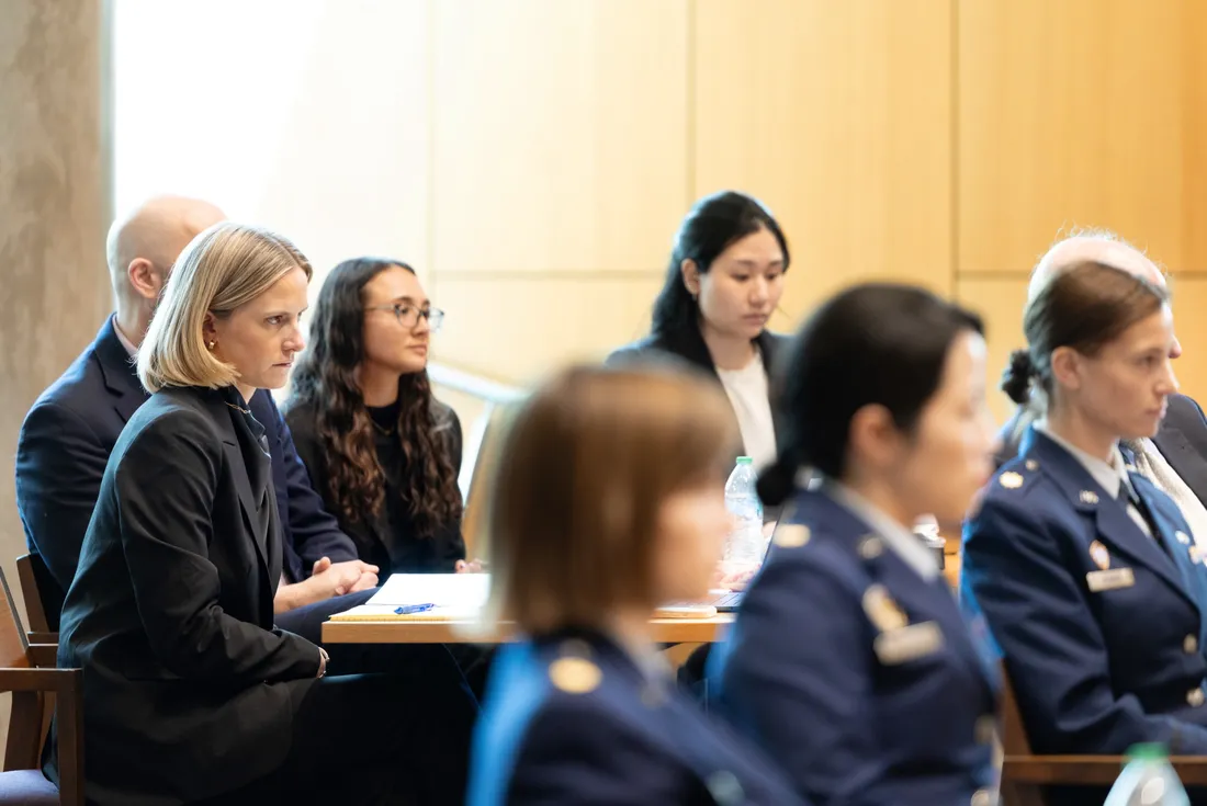 College of Law student Bess Murad sitting in Syracuse University's Dineen Hall participating in a military court hearing.