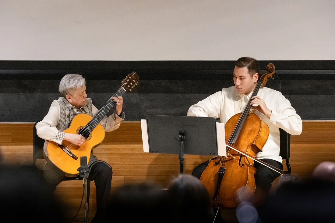 Michael Dadap and Aiden McGorry preforming string instruments.