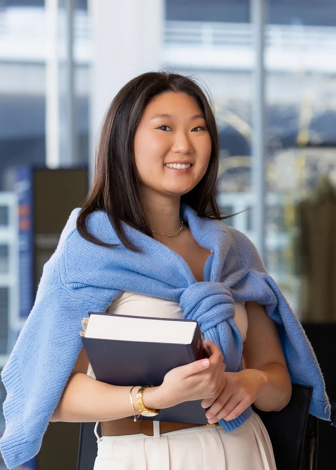 A person holding books in the student veteran center.