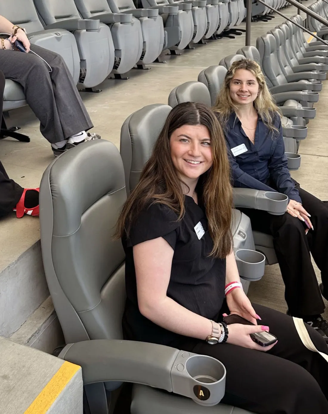 Gia Becchi ’28 sitting in the BMO stadium in Los Angeles as part of an immersion trip tour.