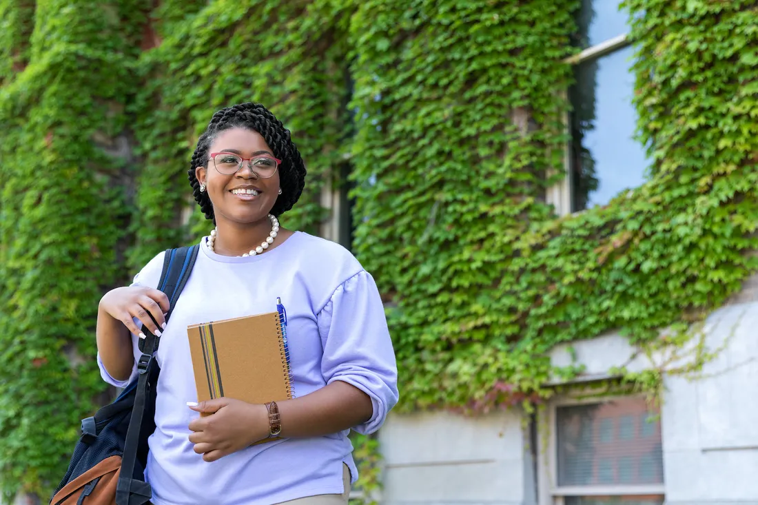 Jazmine Richardson poses for portrait outside of campus building.