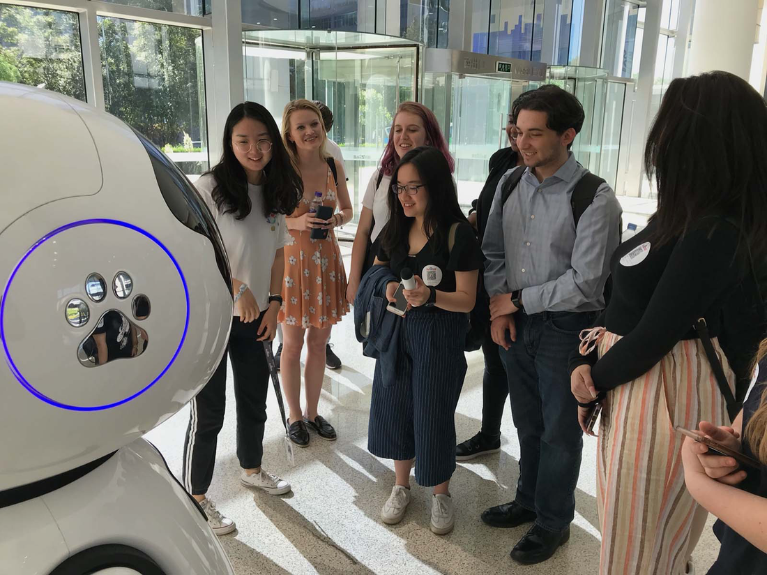 Bandier students interact with robot.