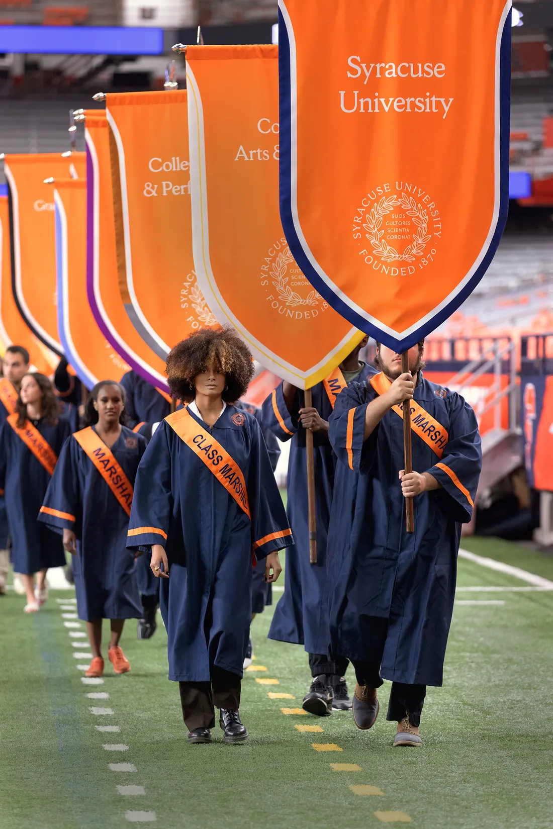 Students walking with banners.