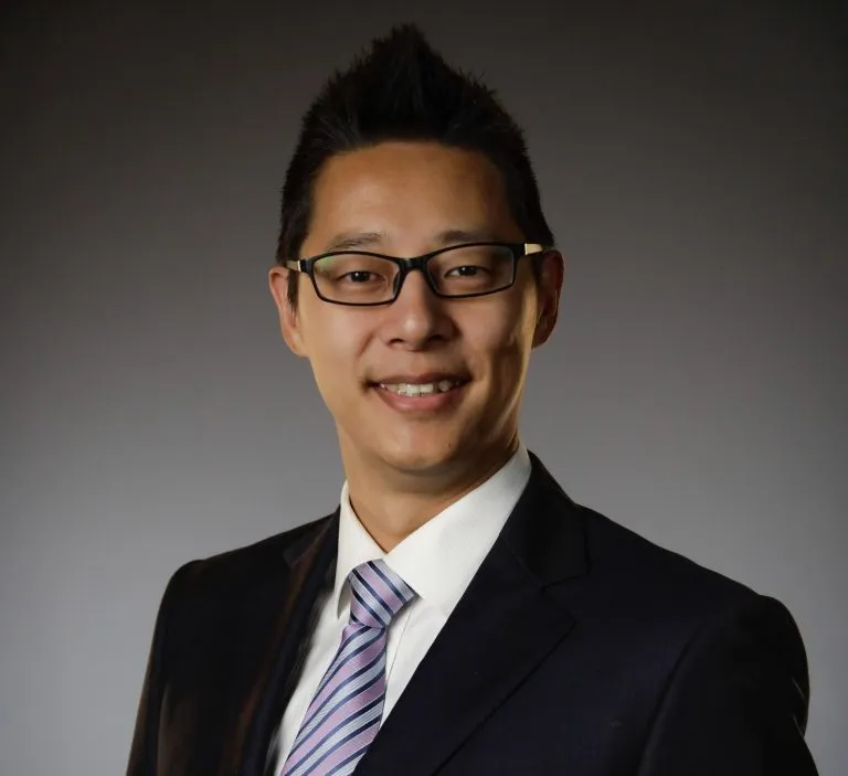 Jerry Huang smiling in a suit.