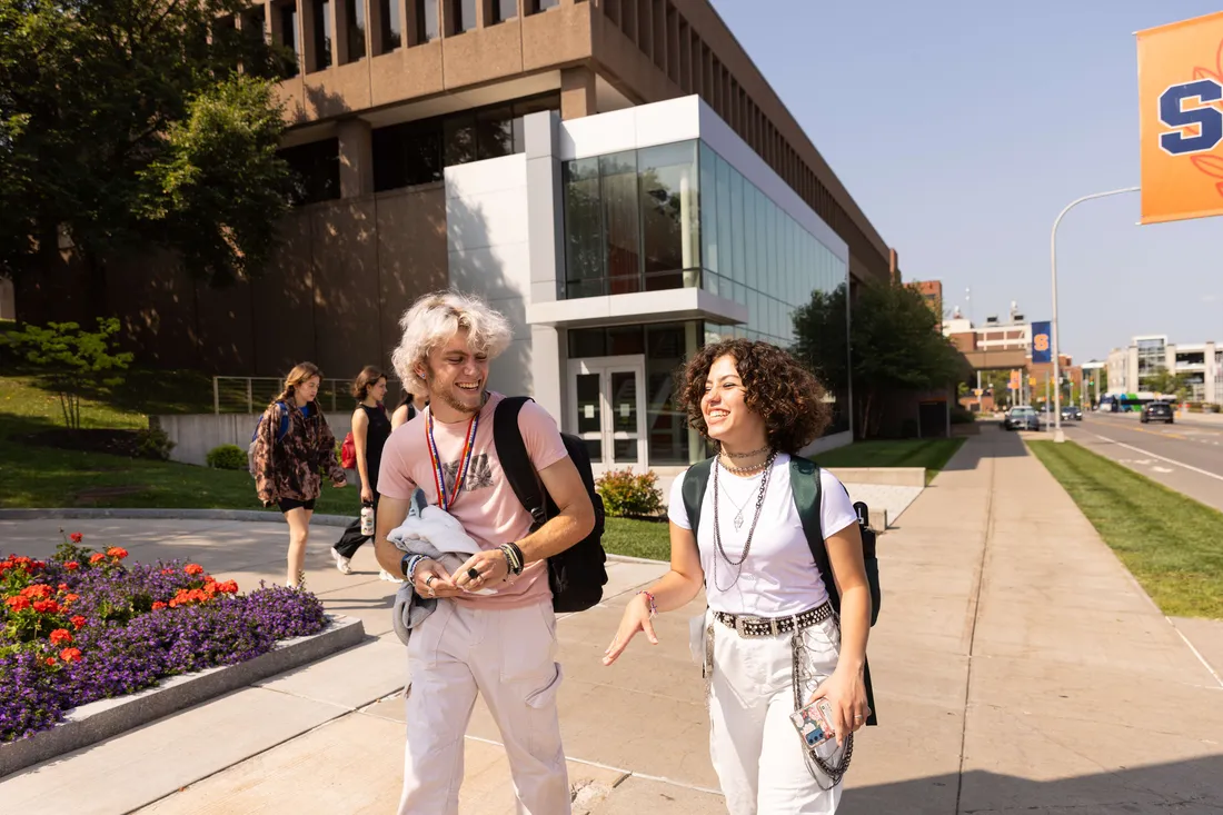 Two students walking on campus.