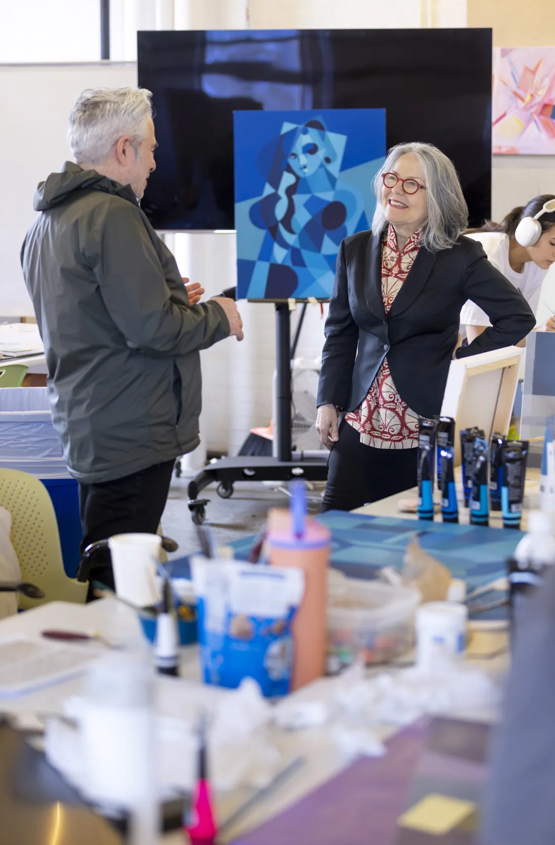Diana Wege '76 speaking with professor Richard Rosa in an art room.