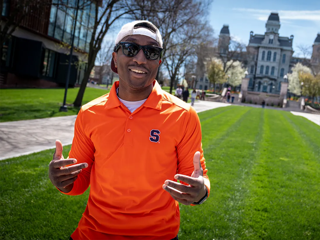 Student Michael Lupton is standing outside the Hall of Languages on campus, smiling.