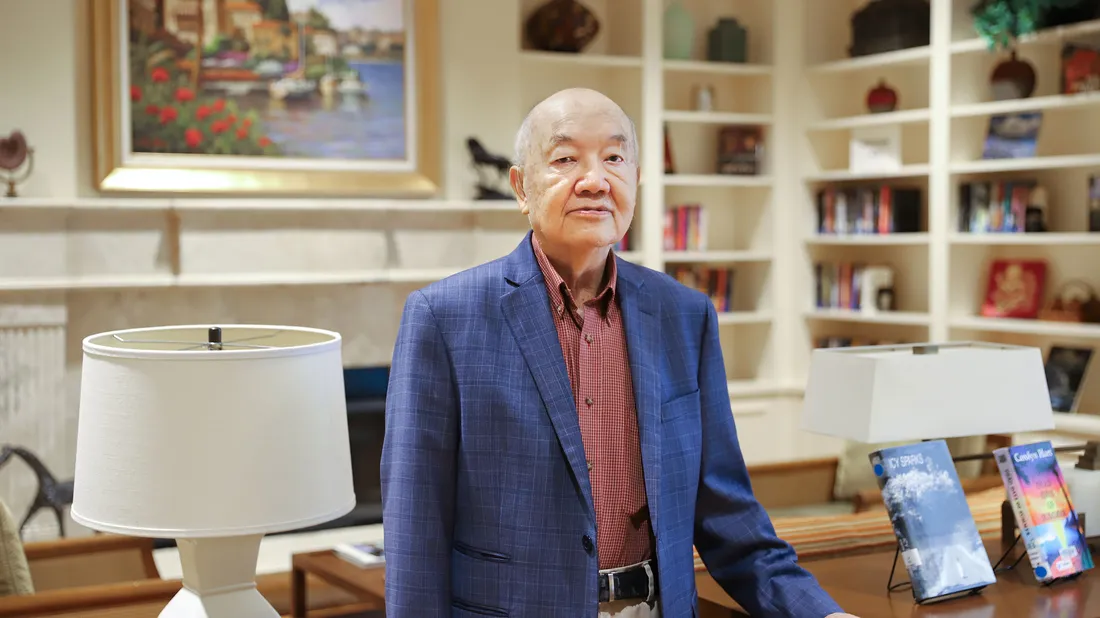 Veteran affiliated student Raul Rosique sitting and smiling at computer.