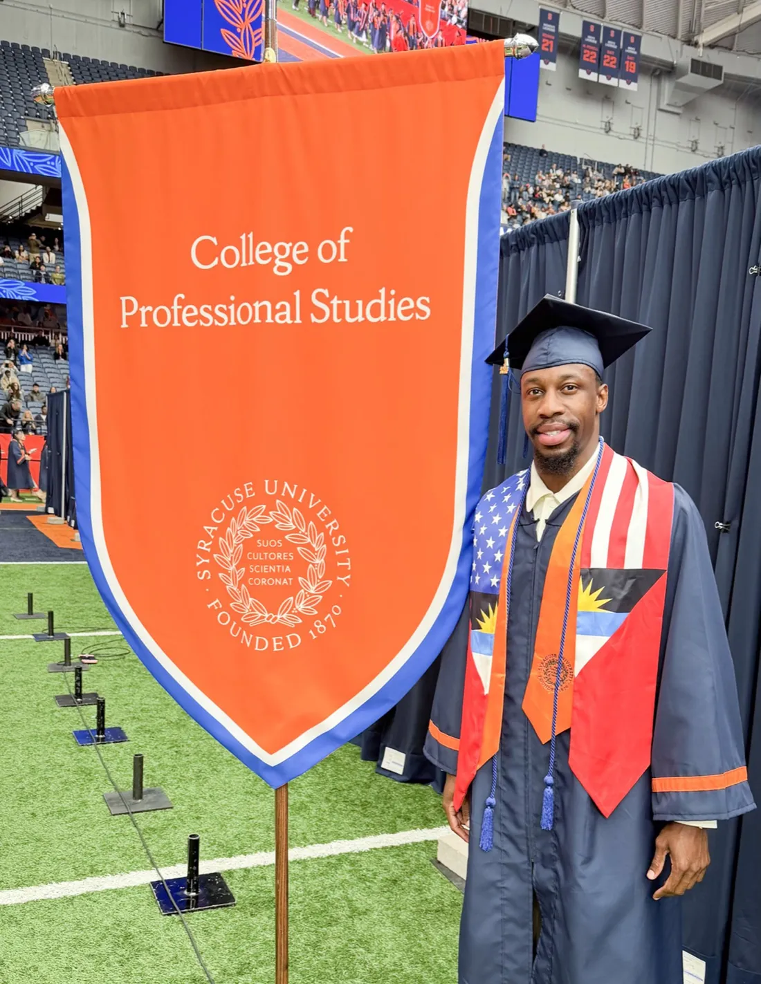 George Lynch ’26 standing in his Commencement regalia.