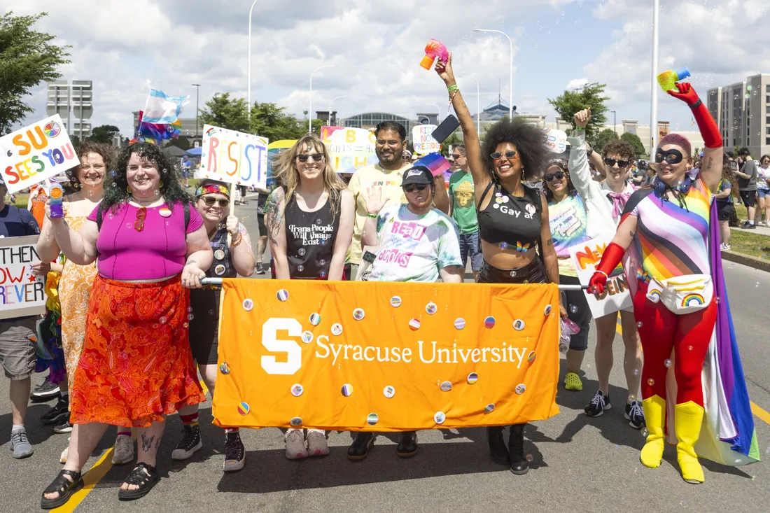 Members of the Syracuse University community standing together at the CNY Pride Parade.