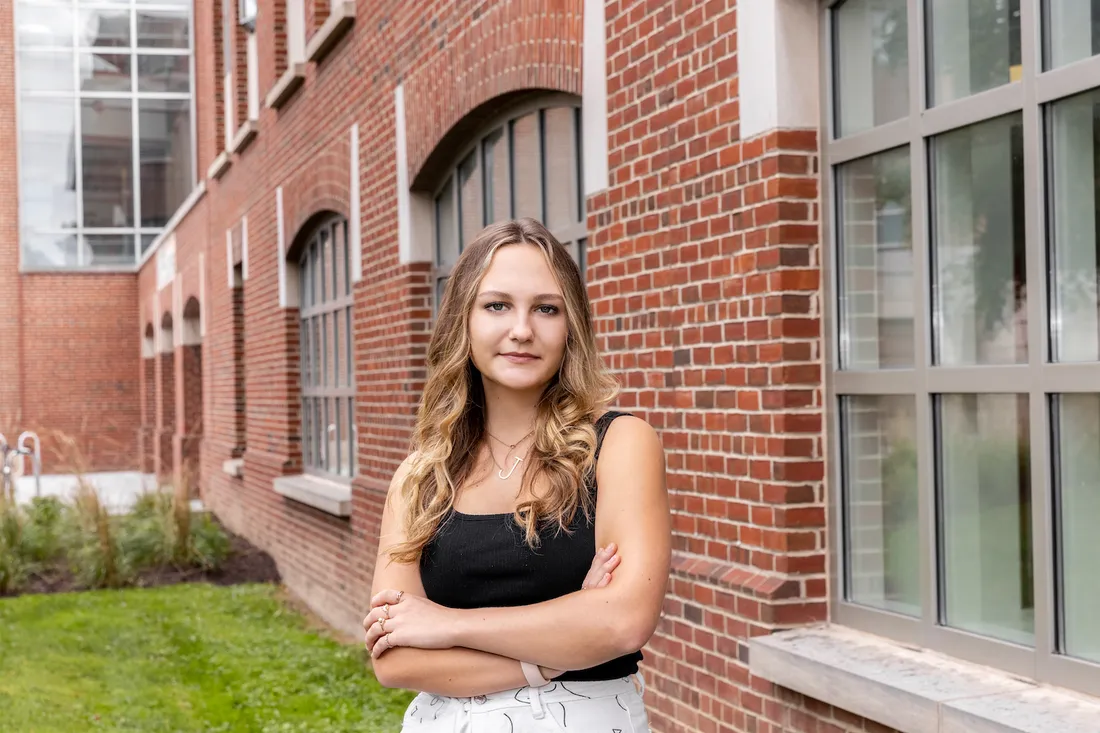 Portrait of Julia Fickenscher in front of the Falk College of Sport and Human Dynamics.