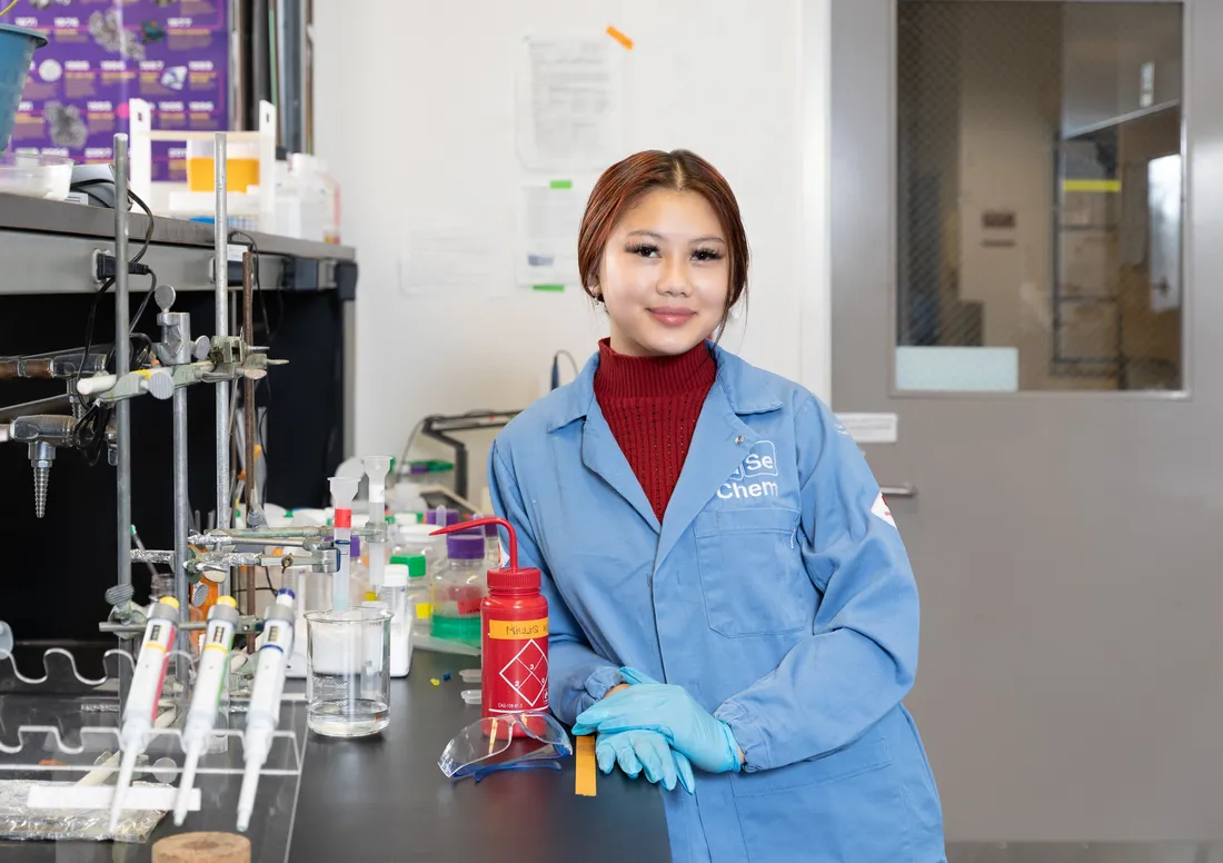 portrait of Quyen Pham in a lab coat in a laboratory