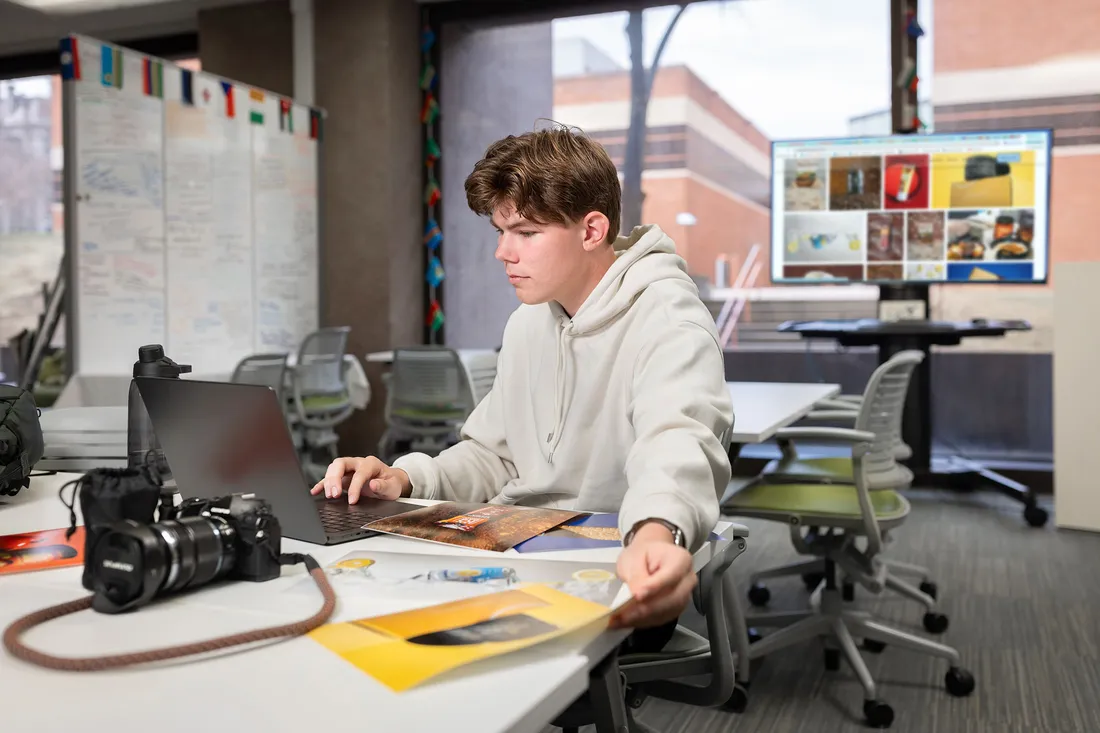 Student working on laptop in photography studio