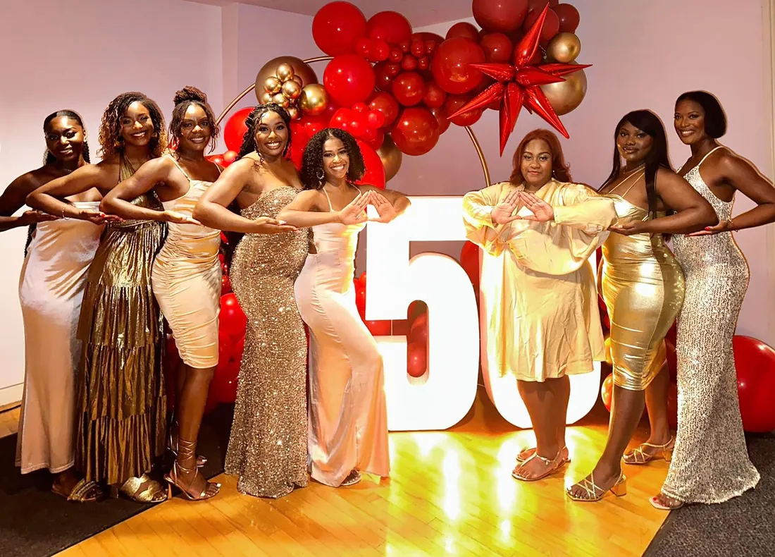 A group of people posing in dresses.