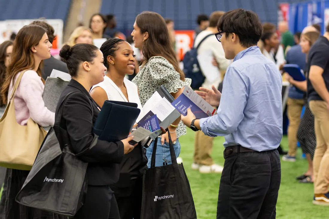 People talking at a career fair.