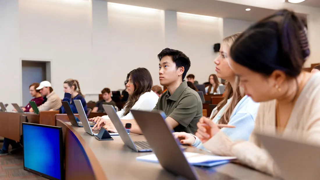 Students sitting in a classroom listening to lecture.