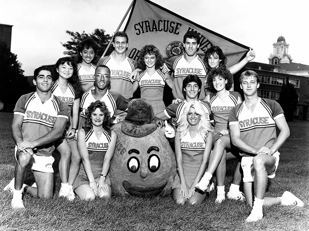 Archived Otto and cheerleaders posing for picture on field.