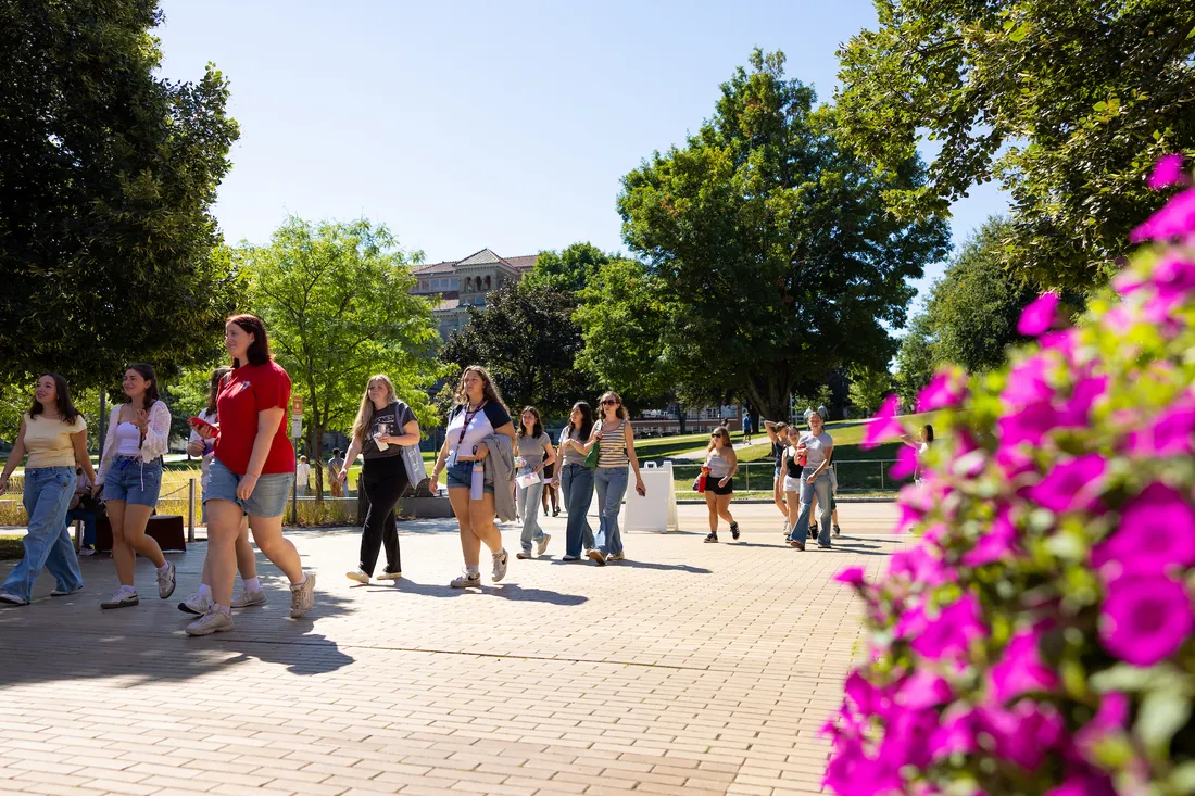 Students outdoors walking on campus.