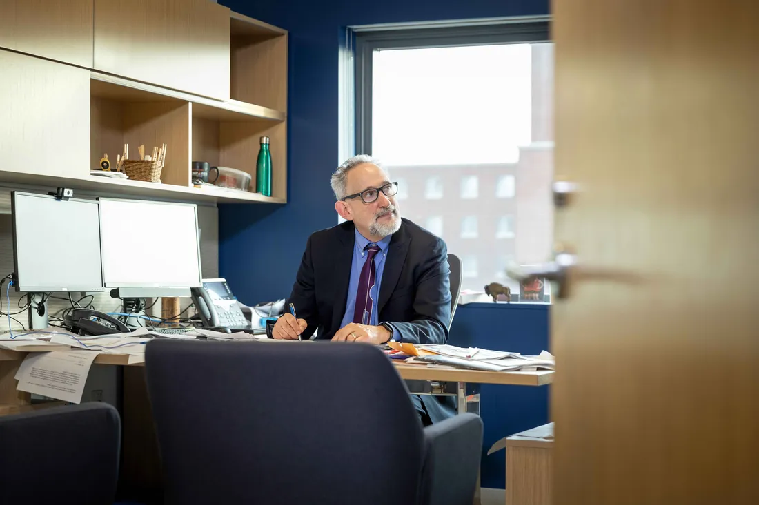 Professor David Driesen sitting at desk.