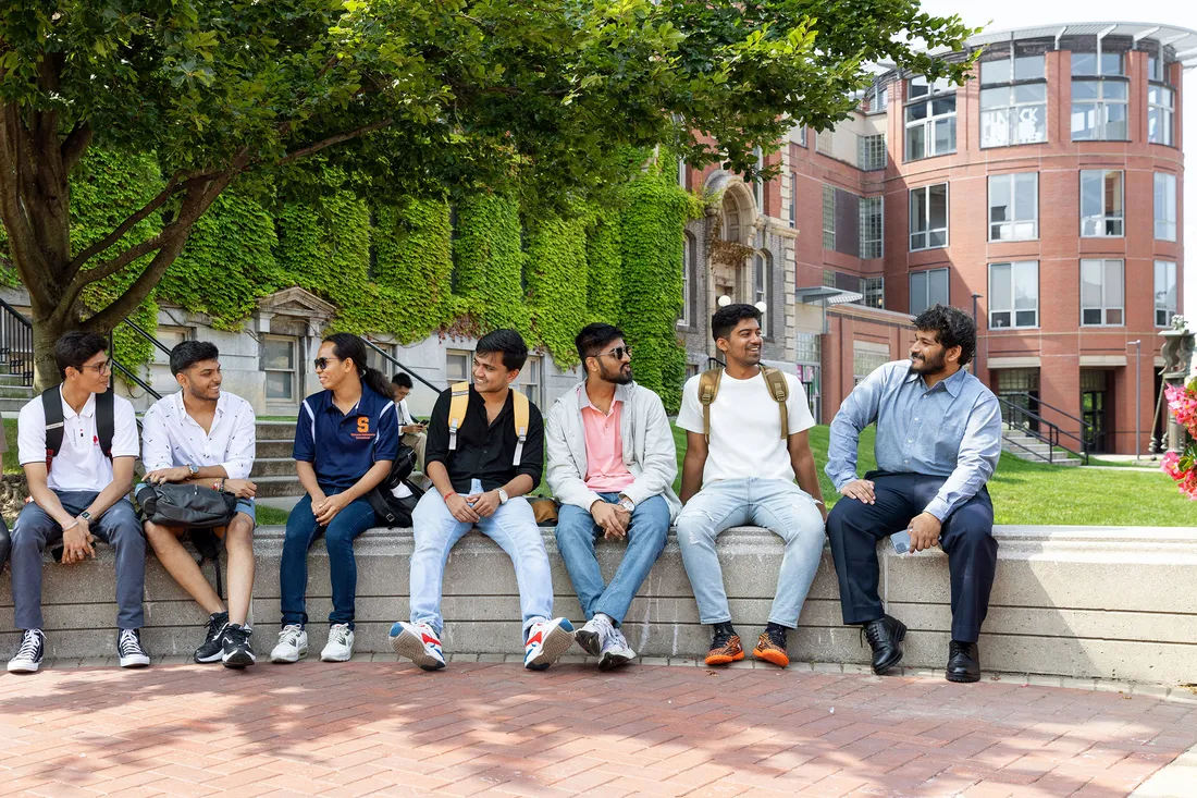 People sitting on bench.