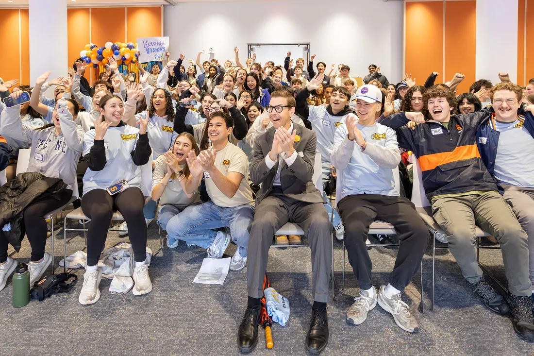 A group of people at the volunteer kick off for orange seeds.