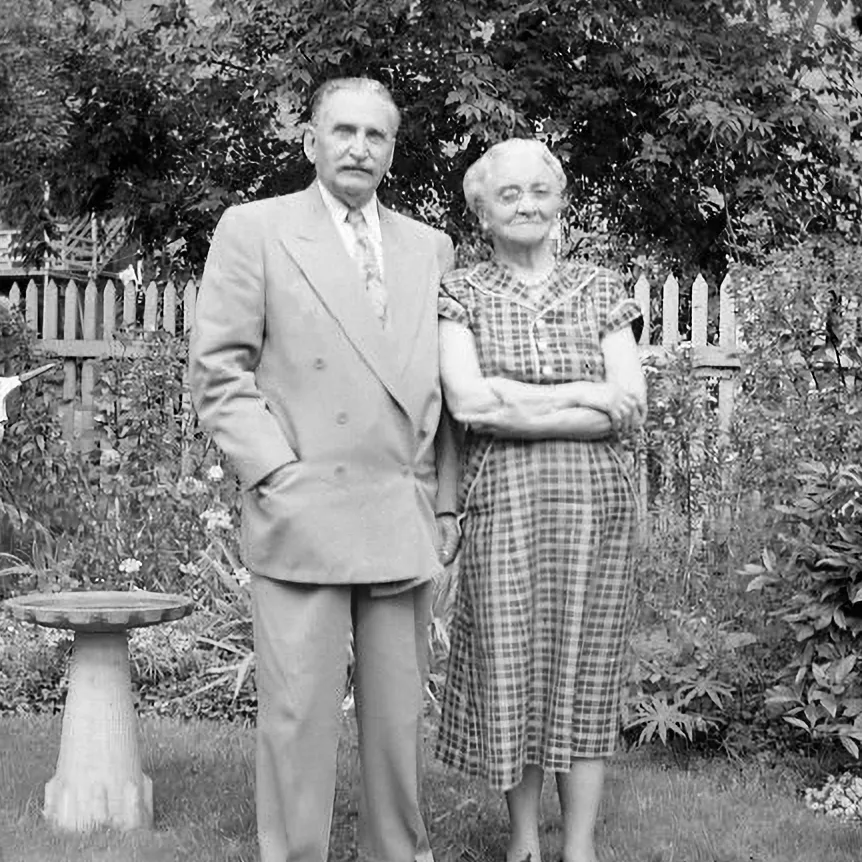 Two people standing in a garden.
