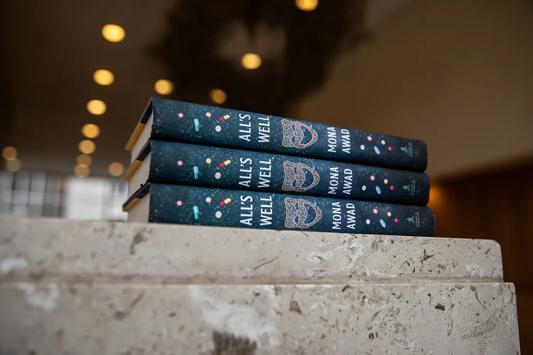 Stack of three books on table.