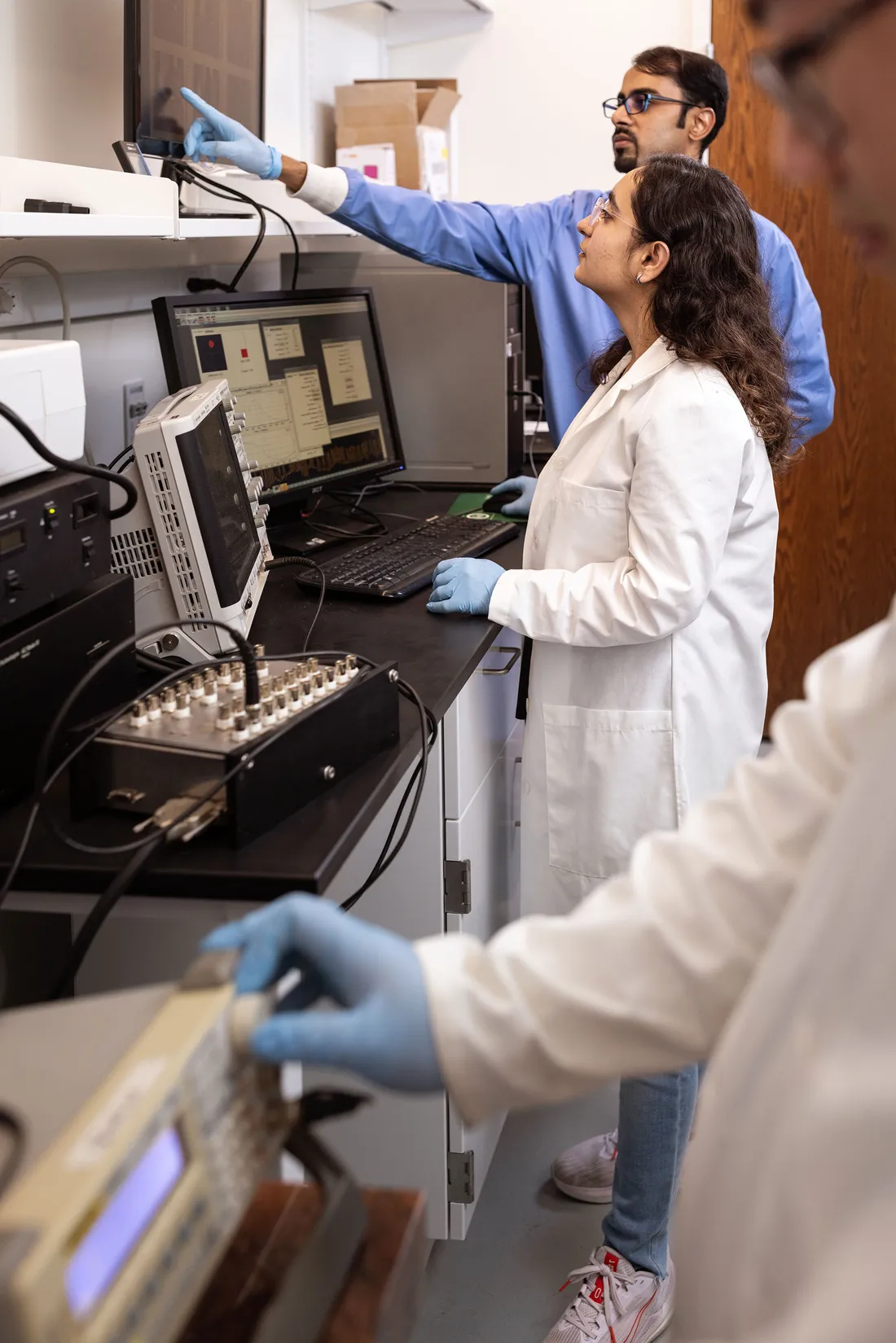 Two people working on lab equipment.