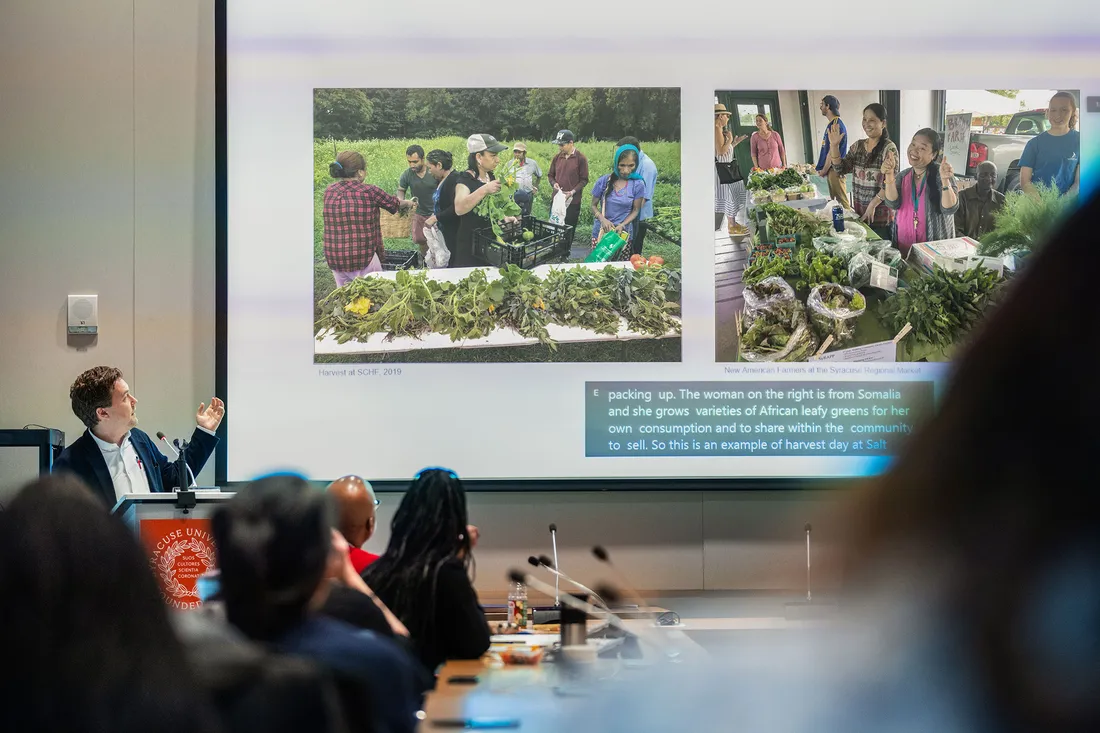 Person presenting to group of people.