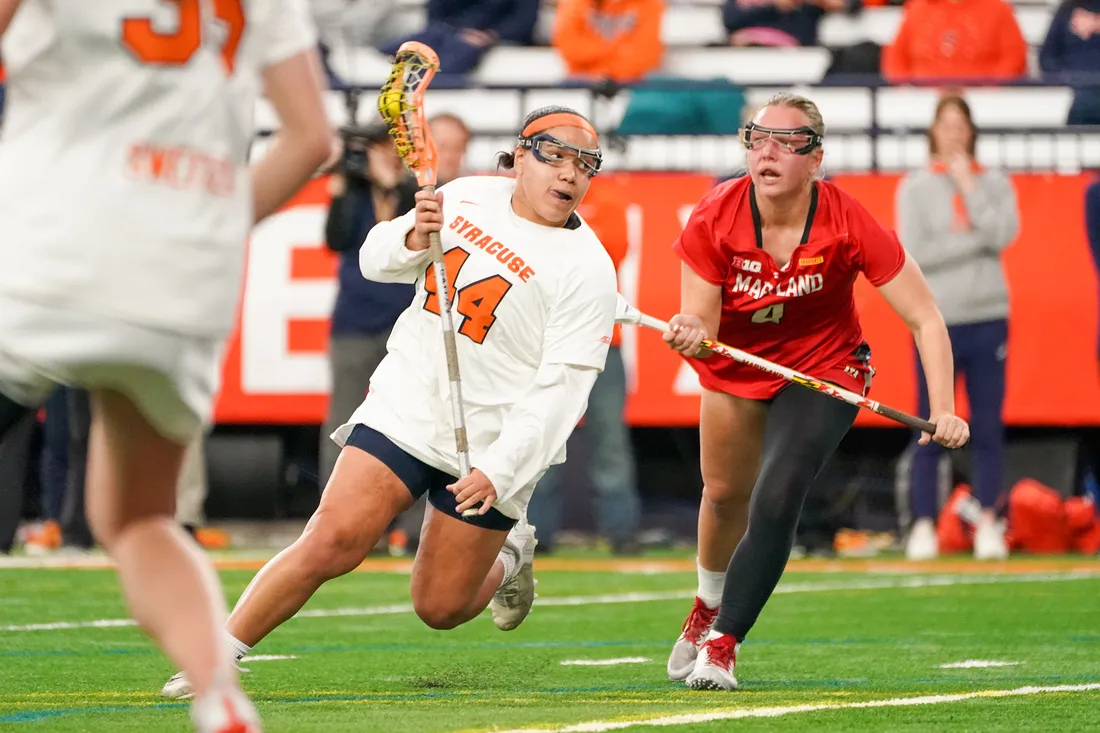 Lacrosse player Emma Ward dodges past a defender in the dome during a lacrosse game.