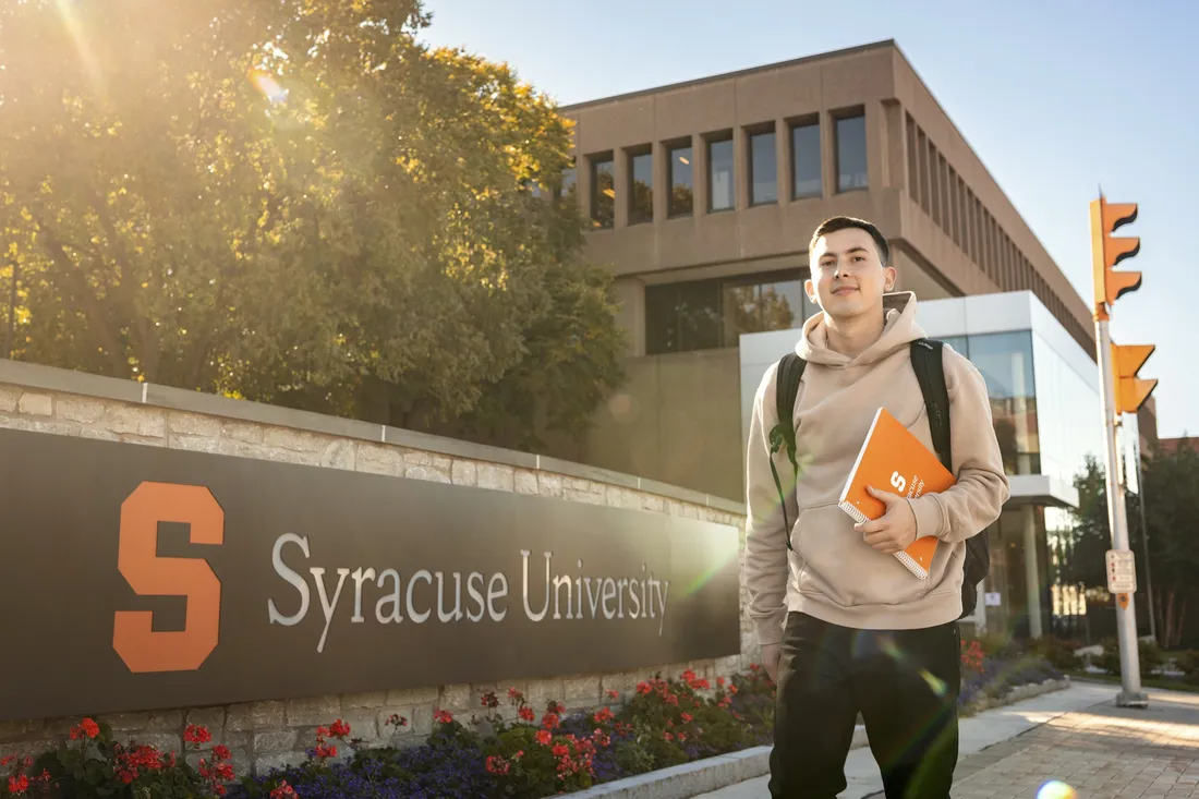 Student Luke-Backman walking on campus.
