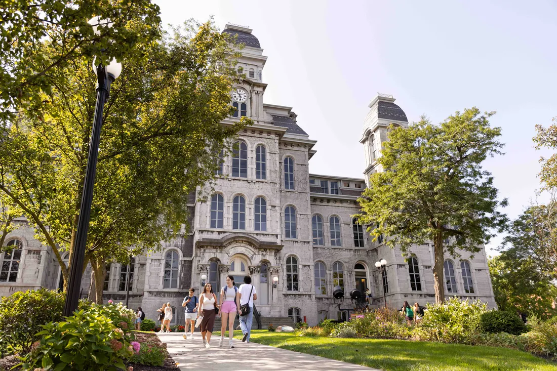 Students walking on campus in front of the Hall of Languages.