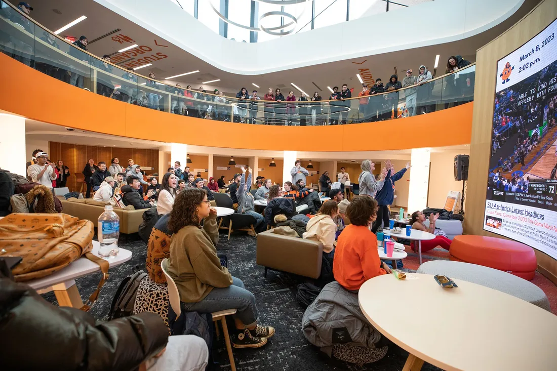 Students watching a basketball game at the Schine Student Center.