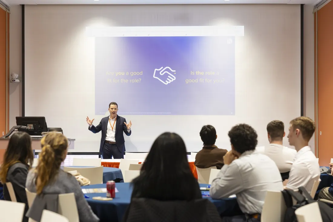 Syracuse University alumnus Greg Sexton presents at the 2026 Career Conference to a group of students.