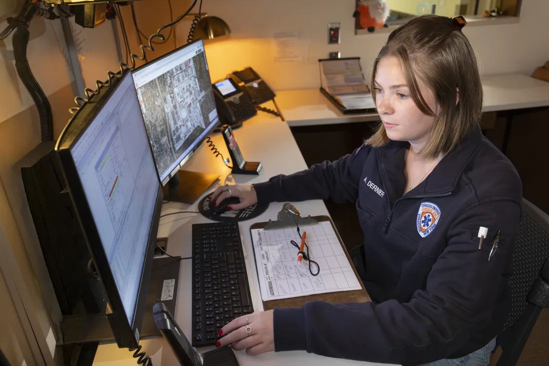 Person working on computer at EMT Dispatch Center.