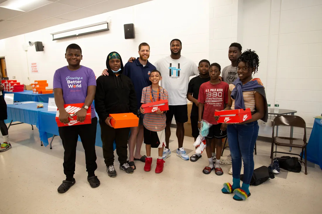 Group photo of Latavius Murray and students in the community.