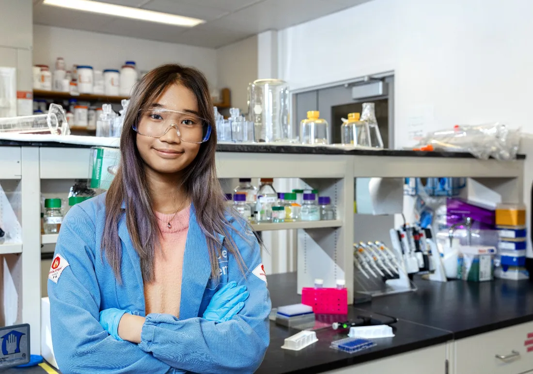 portrait of Ngoc Huynh in a lab coat in a laboratory