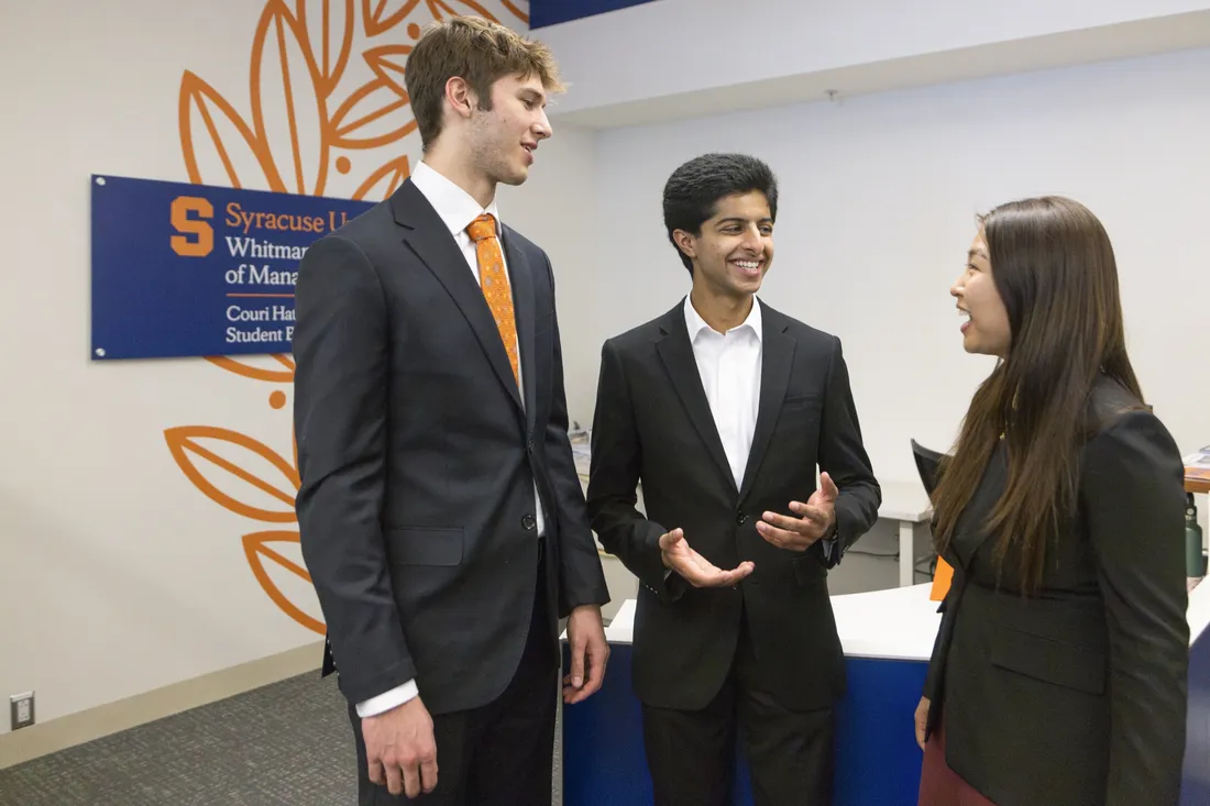 Students attending the Panasci Business Plan competition speaking to one another.