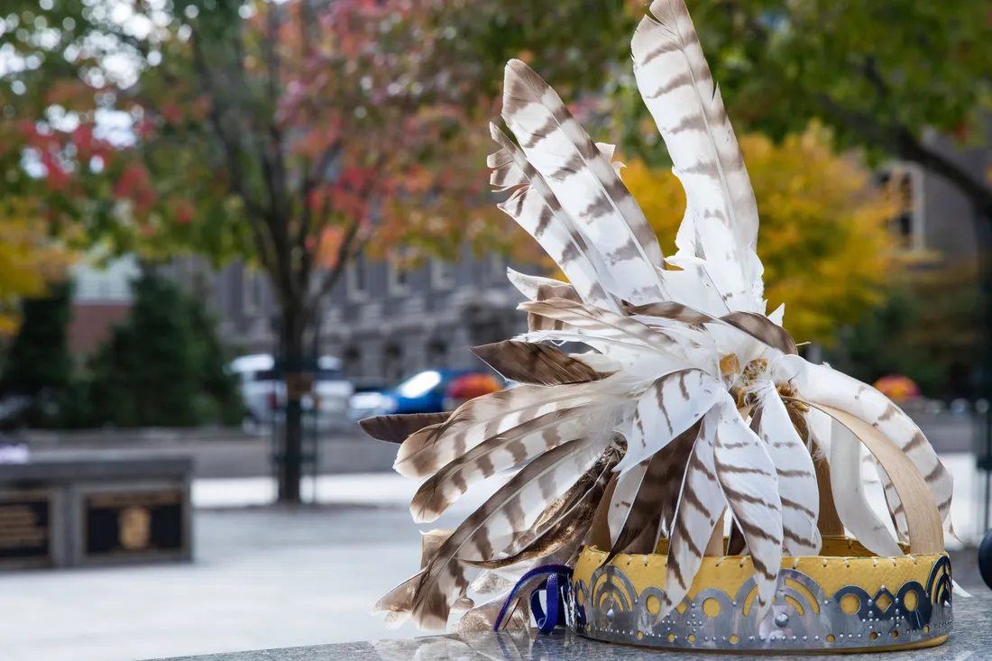 Native American head piece sitting outside.