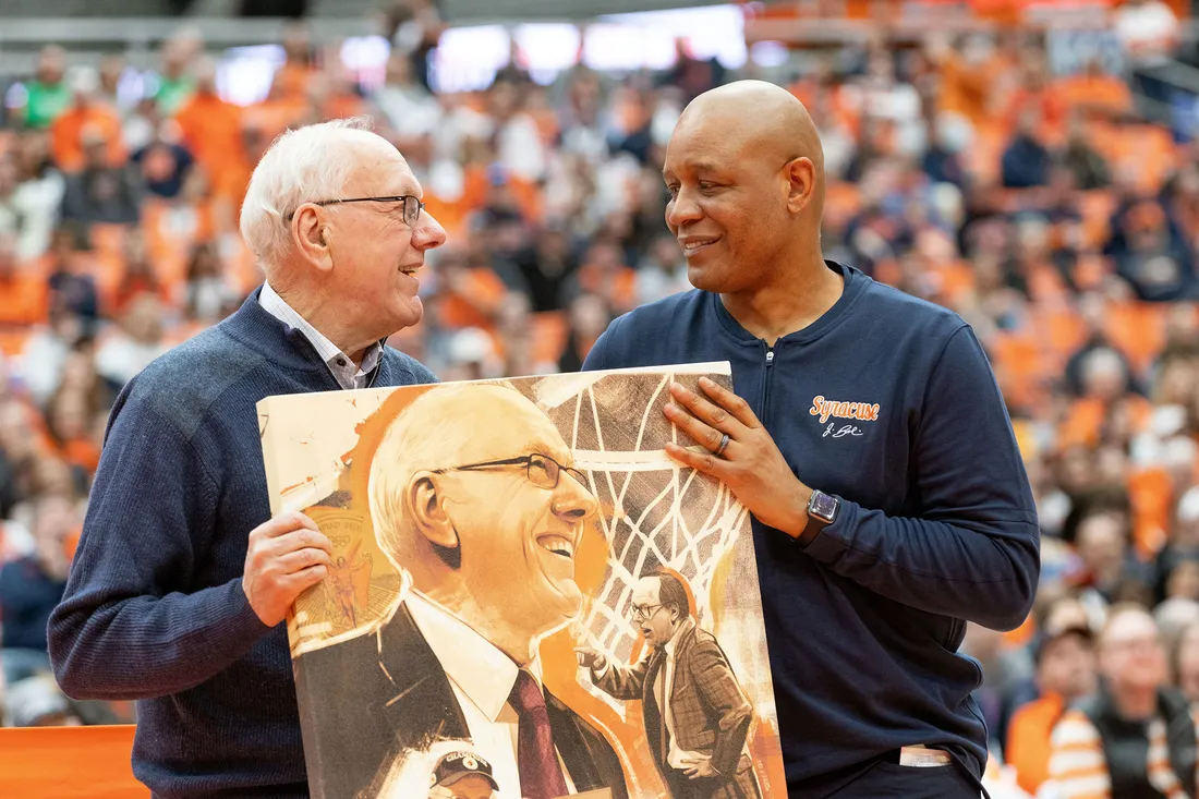 Jim Boeheim and Adrian Autry smiling and talking.