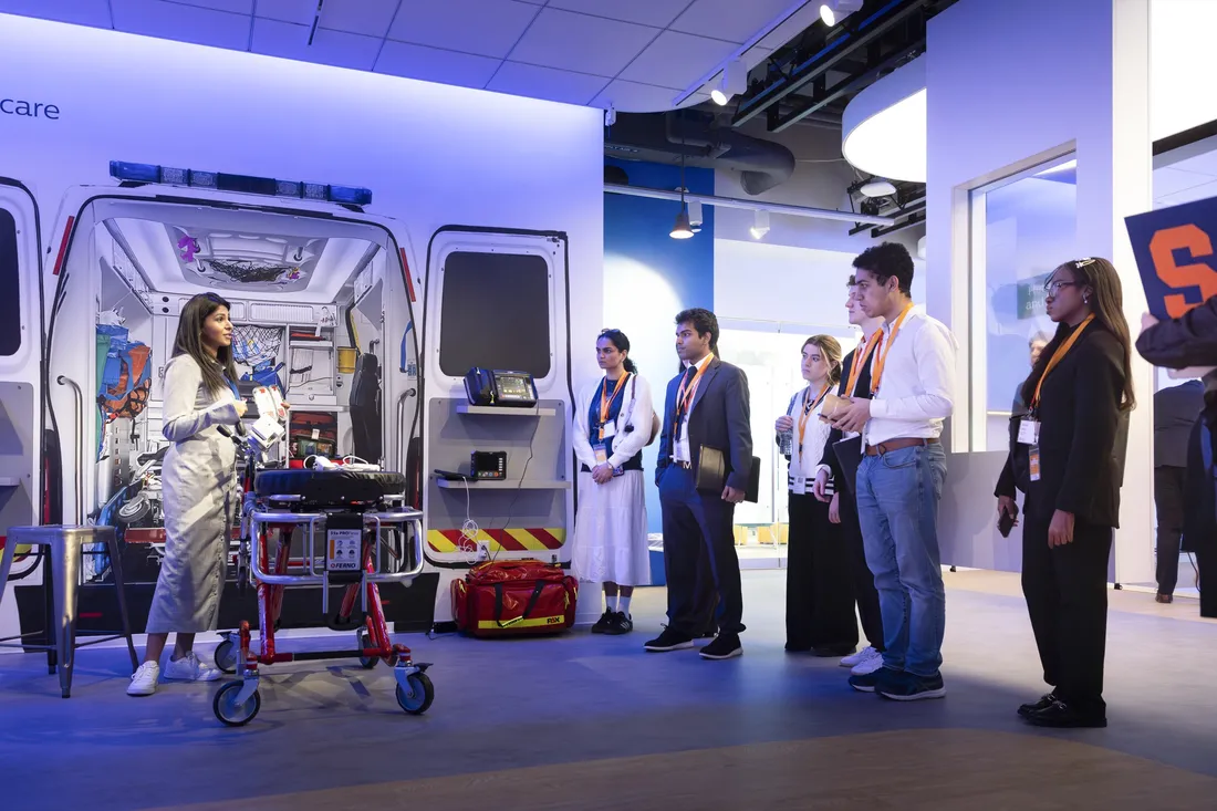 Group of students attending Syracuse University's Boston immersion trip watching a demo of medical technology equipment.