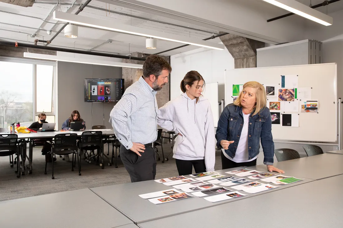 Student from the College of Visual and Performing Arts School of Design working with professors.